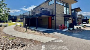 A modern two-story building with a covered outdoor area and a curved driveway. - 40 Mins to Glacier Park, 5 Mins to City Beach & DT (Whitefish)