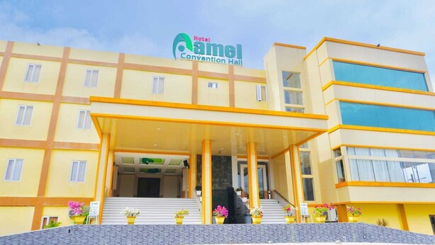 A hotel with a yellow facade, a covered entrance, and a sign reading "Hotel Camel Convention Hall". - Hotel Amel Convention Hall (Banda Aceh)