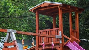 A wooden play structure with a slide, swings, and climbing holds. - Perfect Place for 2 or 3 (Petrich)
