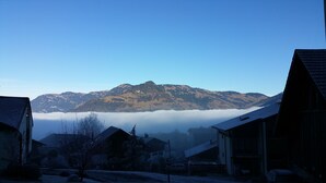 A mountain with a village in the foreground, houses with sloped roofs, and a clear sky. - Elfe - Apartments Apartment for 6 Guests With Patio (Emmetten)