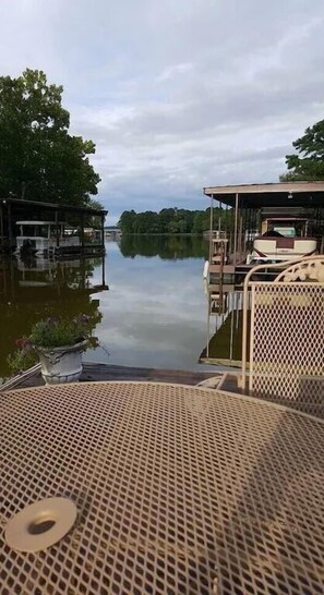 A calm lake with docked boats and a covered seating area. - Waterfront Listing - 3 Bedroom 3 Bath on Secluded Private Cove,great Location (Hot Springs)