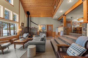 A cozy interior with a fireplace, seating area, and a view of the outdoors.