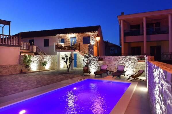 Relax by the pool surrounded by a balcony and lounge seating.