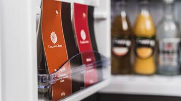 A refrigerator stocked with various beverages and packaged food items.