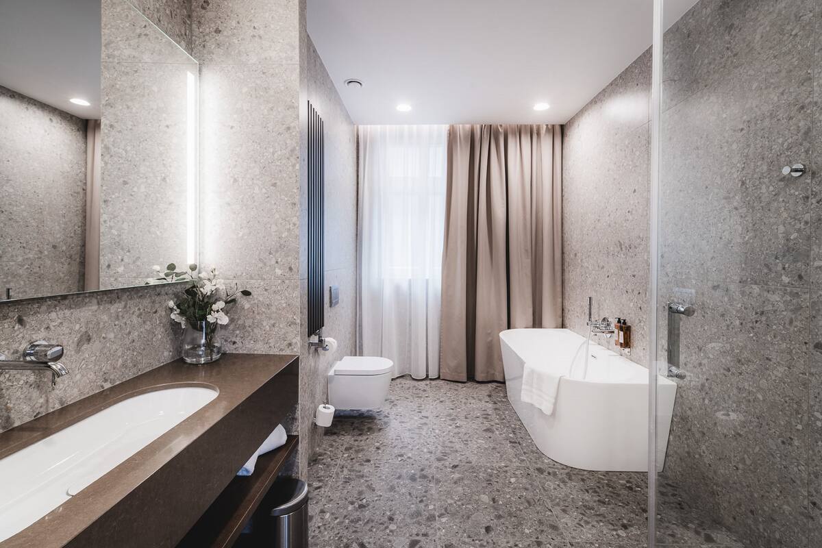 deluxe apartment | bathroom | shower, rainfall showerhead, hair dryer, bathrobes