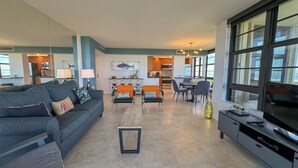 A modern living room with a grey sofa, a coffee table, and a TV stand. - South Seas Tower 4- 812: Beautifully Updated; Large Balcony (Marco Island)