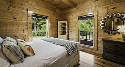 Large authentic 3-story log cabin adjacent to lake. Up to 14 guests.