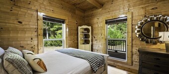 Large authentic 3-story log cabin adjacent to lake. Up to 14 guests.