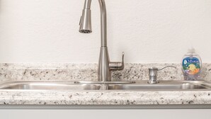 A kitchen with a stainless steel sink, a single faucet, and a wall-mounted clock. - ◆ Sensational Apartment! 2 Bed 1 Bath - Sleeps 4 ◆ (Colorado Springs)
