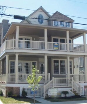 A two-story building with a balcony on the upper floor.