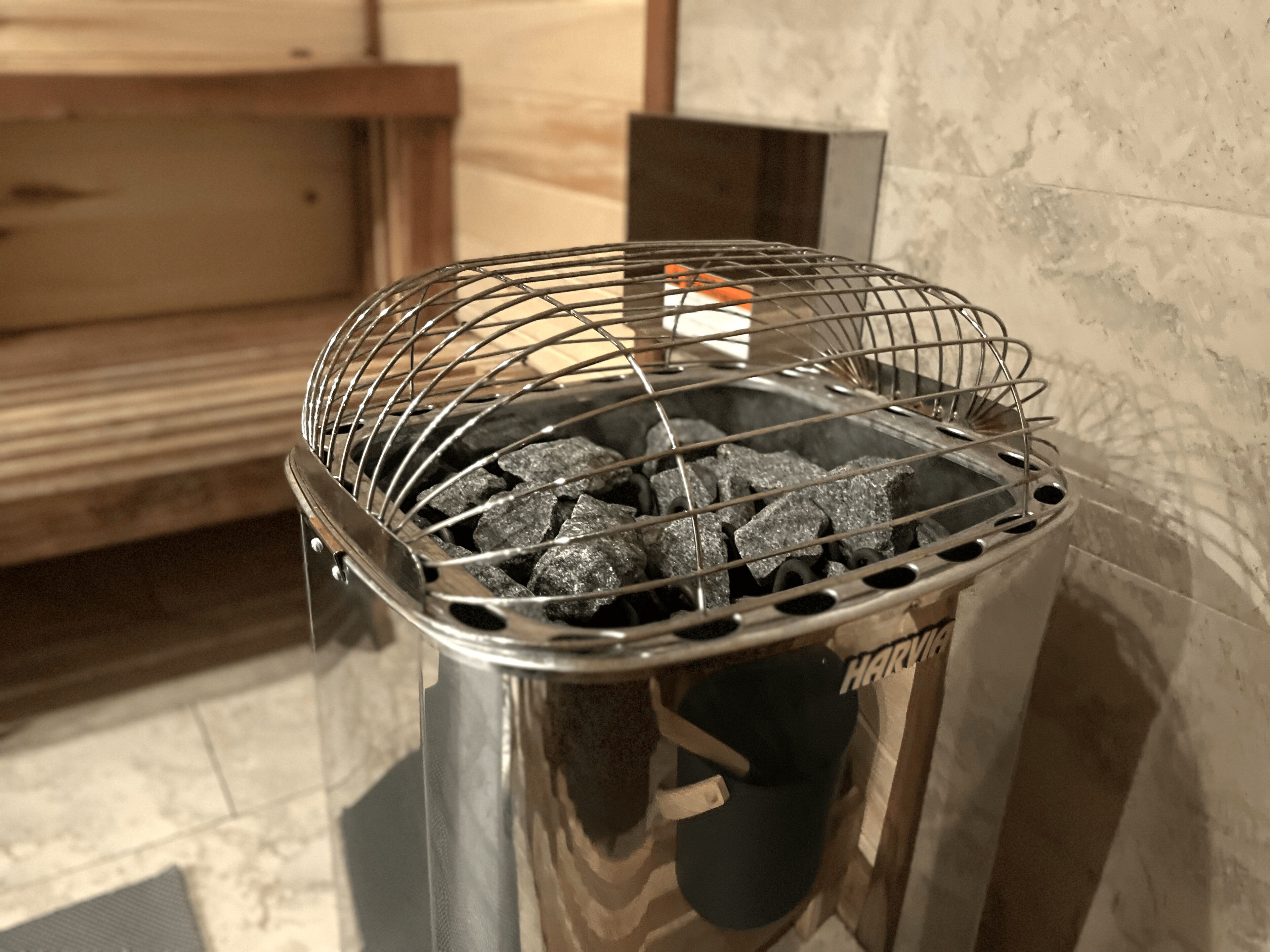 A metal grill with charcoal in a kitchen area.