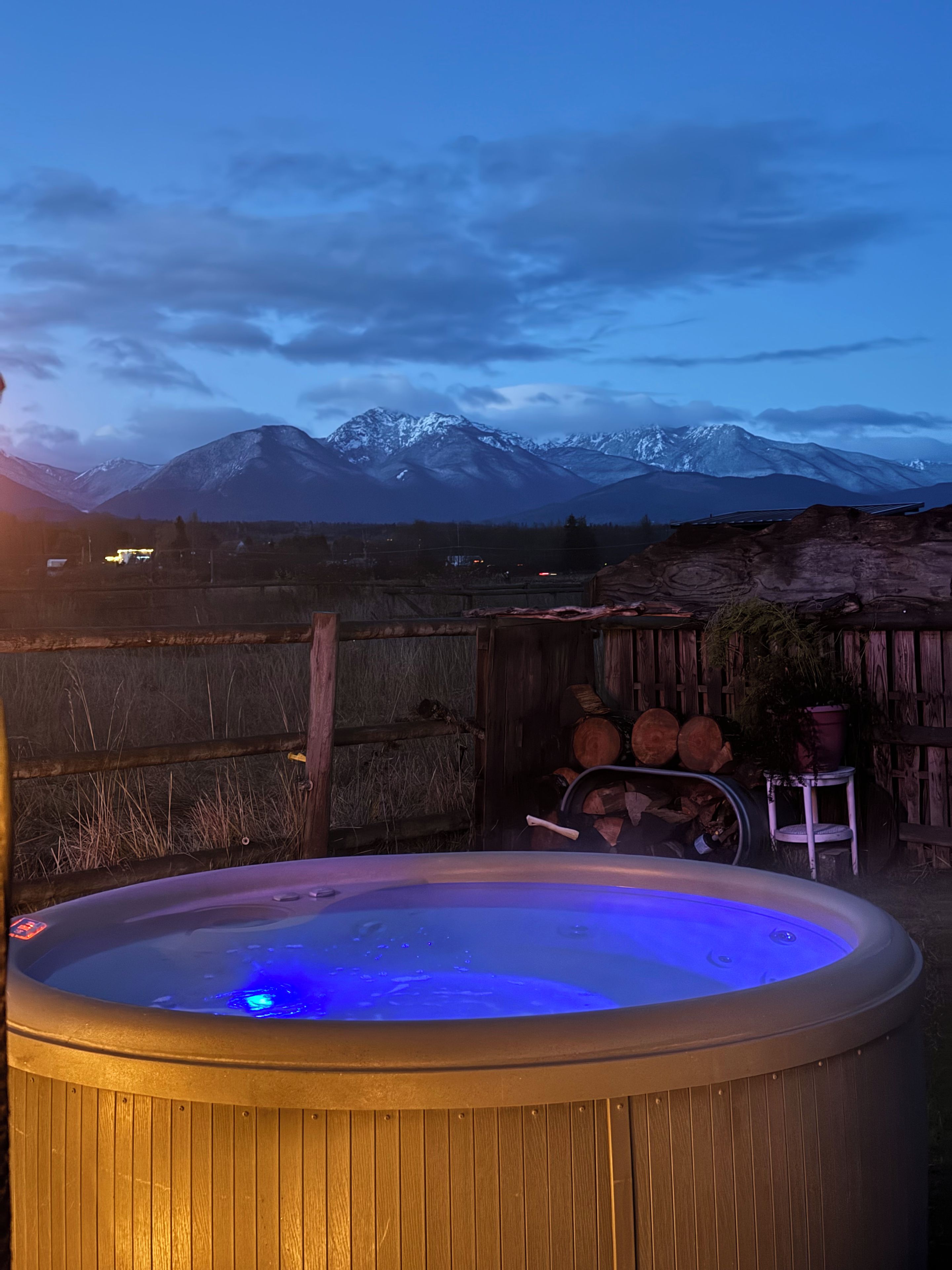 Ein Whirlpool mit Blick auf schneebedeckte Berge im Hintergrund.