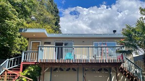 A two-story house with a balcony, a garage, and a staircase. - Dog 🐾 friendly home with a view 🌅 near airport ✈️ (Des Moines)