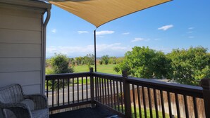 A porch with a view of a green landscape and a clear sky. - Cozy Colorado home with Serene views meant for pure relaxation! (Henderson)
