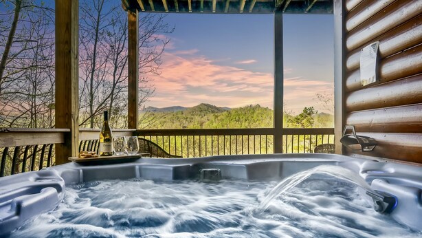 A hot tub with a view of a mountainous landscape. - Ranked Top 1% Cabin-Location-Views-Hot Tub-Games (Pigeon Forge)