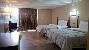 A hotel room with two beds, a desk, a chair, and a window with curtains. - Hotel Weston RFD (Rockford)