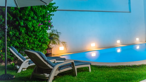 A swimming pool with lounge chairs and an umbrella. - Beautiful home with private pool (Puerto Vallarta)