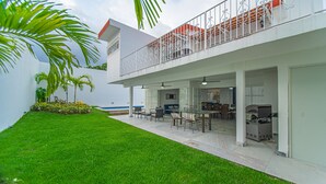 A modern two-story house with a covered patio, outdoor furniture, and a swimming pool. - Spacious House with Private Pool (Puerto Vallarta)