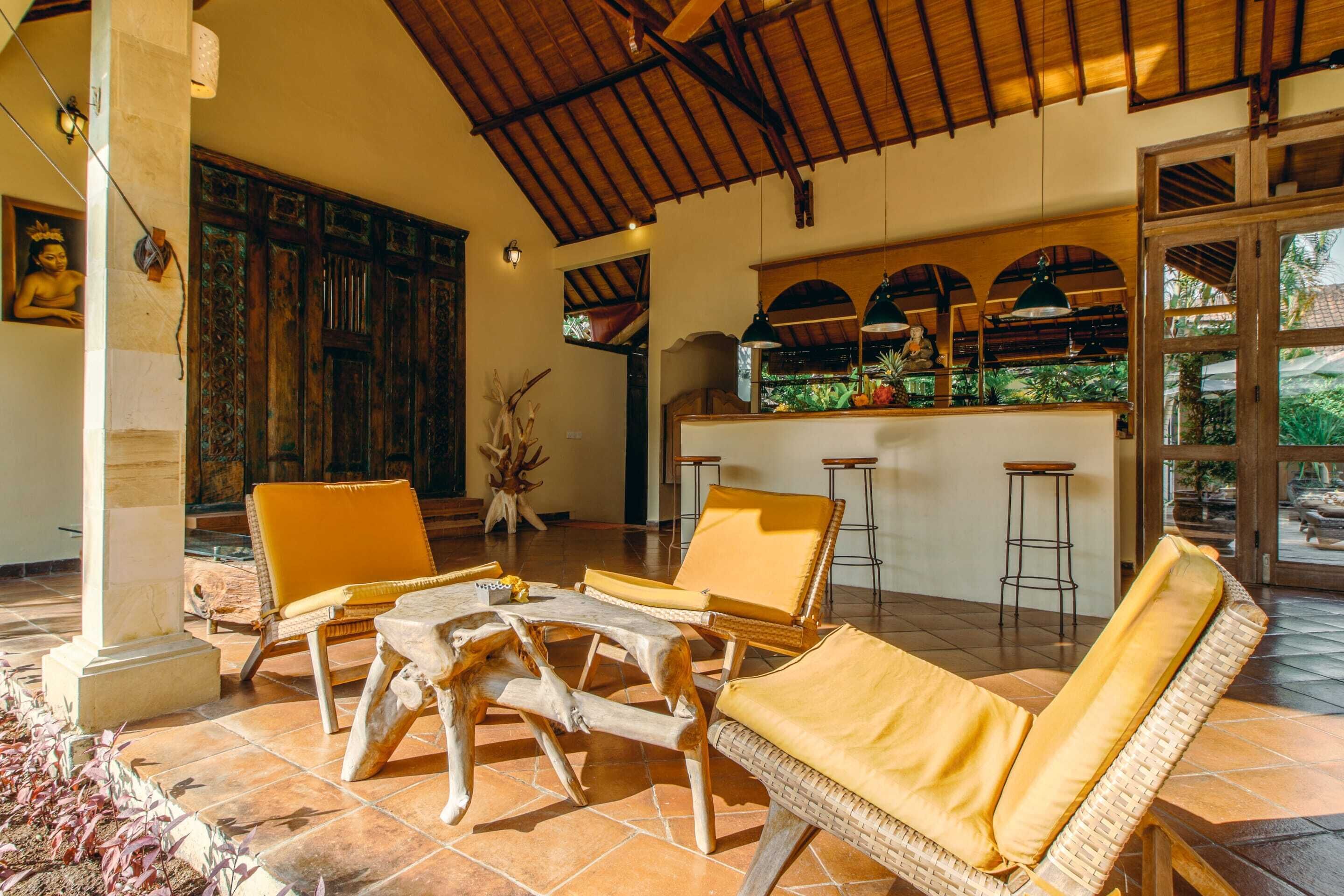 A spacious patio with wicker furniture and a bar area.