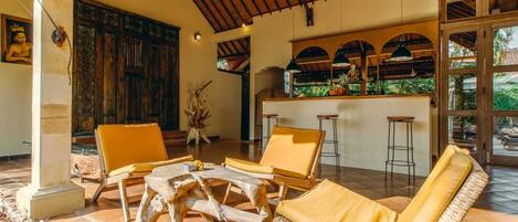 A spacious patio with wicker furniture and a bar area.