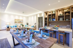 Enjoy meals together at the central dining table, surrounded by comfortable seating and stylish decor.