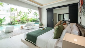 A modern bedroom with a large bed, a view of a pool, and a balcony with outdoor furniture. - Villa Clemence (Canggu)
