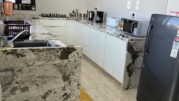 Fridge, microwave, stovetop, coffee/tea maker