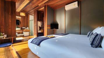 A modern bedroom with a large bed, wooden ceiling, and a walk-in closet.