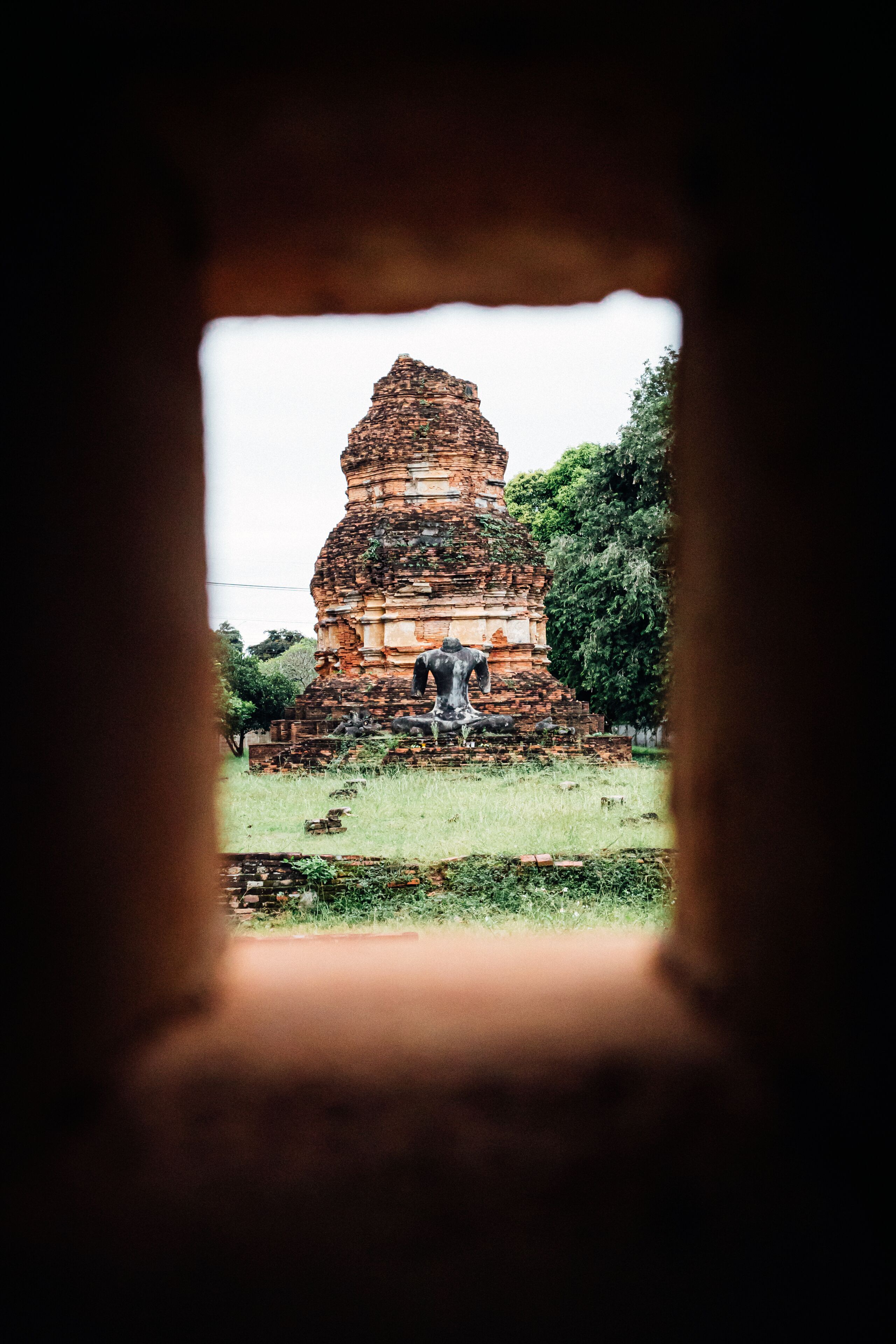 A temple with a tiered roof structure, surrounded by greenery.