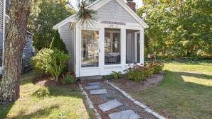 A small white cottage with a covered porch, labeled "Beach Walk Cottage 3702". - Walk 1/10 Mile to Lecount Hollow Beach! (Wellfleet)