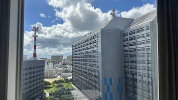 A view of modern buildings with a prominent tower and a building with blue patterns.