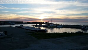 En lystbådehavn med fortøjede både, en klar himmel og en solnedgang.