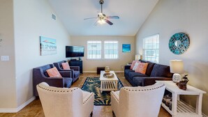 A living room with two sofas, a coffee table, and a TV.