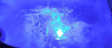 A hot tub with a digital control panel and a blue light.