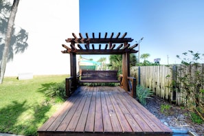 A wooden deck leading to a bench under a pergola. - FREE Golf+Perks!Top of the Gulf Beachfront 703 Spacious Studio w/Great Views! (Panama City Beach)