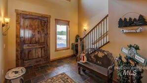 A wooden door, a bench, a staircase, and a sign with 'Winter' and 'Intermountain MLS'.