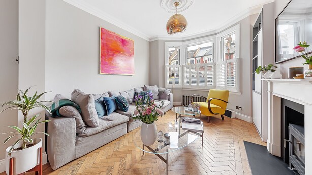 A modern living room with a grey sofa, a glass coffee table, and a yellow armchair. - Clapham Fairytale, by Veeve (London)