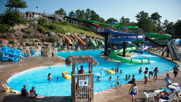 A water park with multiple slides and a swimming pool.