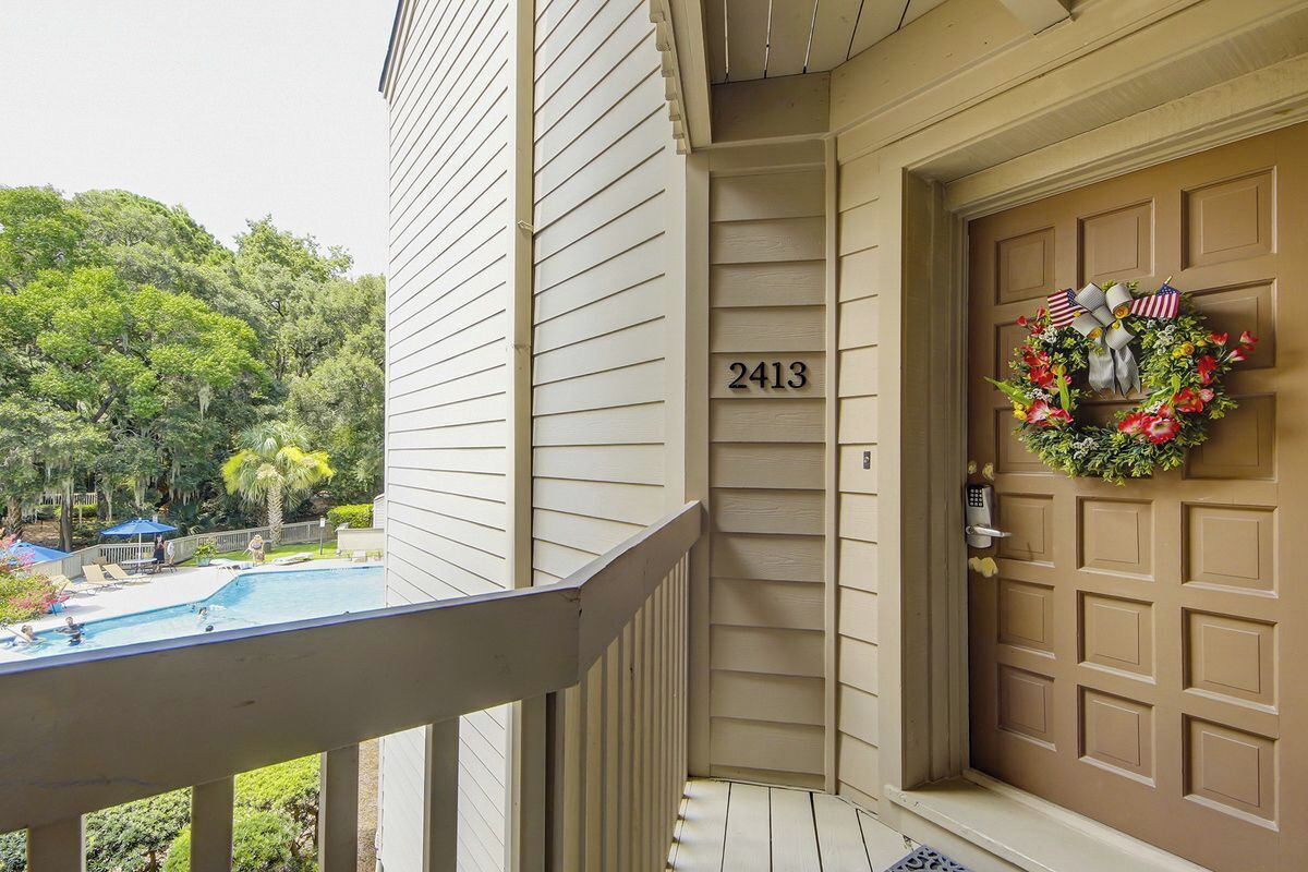 A house with a front door, a mailbox, and a number 2413 on the wall.