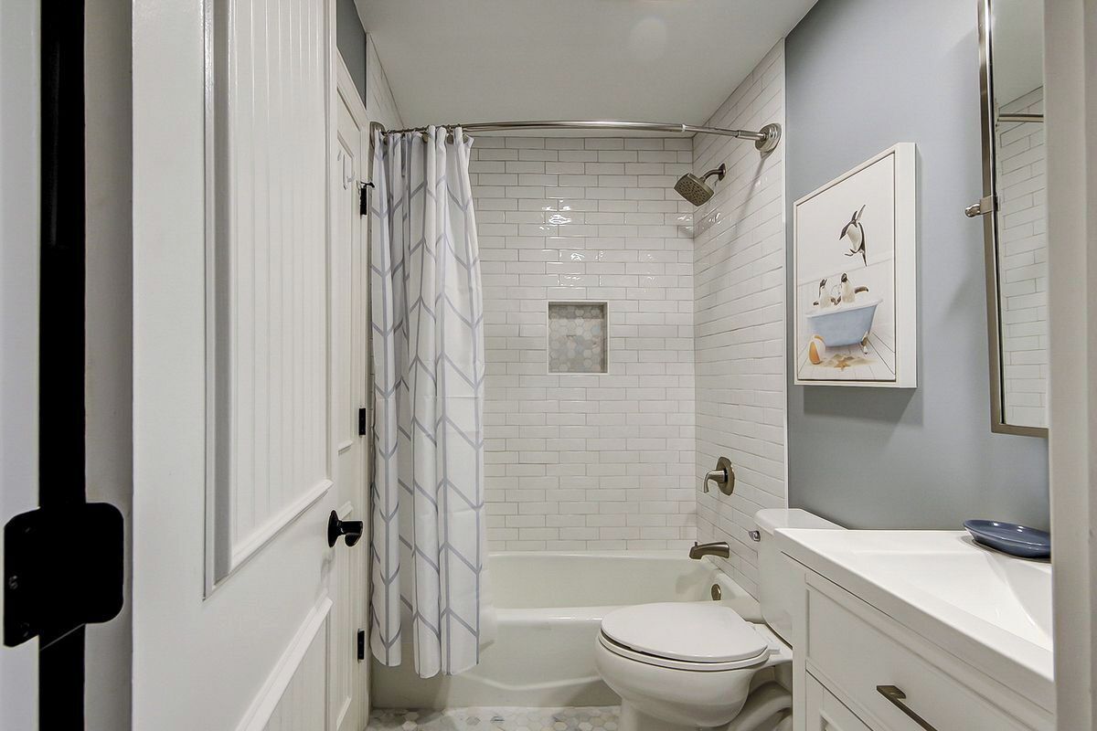 A bathroom with a bathtub, toilet, and sink.