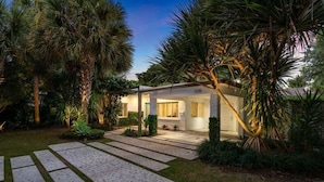 Uma casa moderna com um jardim bem cuidado, uma entrada pavimentada e o número 3310 na fachada.