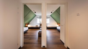 A mirrored hallway leading to two bedrooms with wooden flooring and green accents on the walls. - Luxe 6p - Three Bedroom Villa, Sleeps 6 (Thorn)
