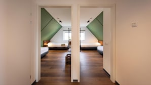 A mirrored hallway leading to two bedrooms with wooden flooring and green accents on the walls. - Premium Outdoor 6p - Three Bedroom Villa, Sleeps 6 (Thorn)