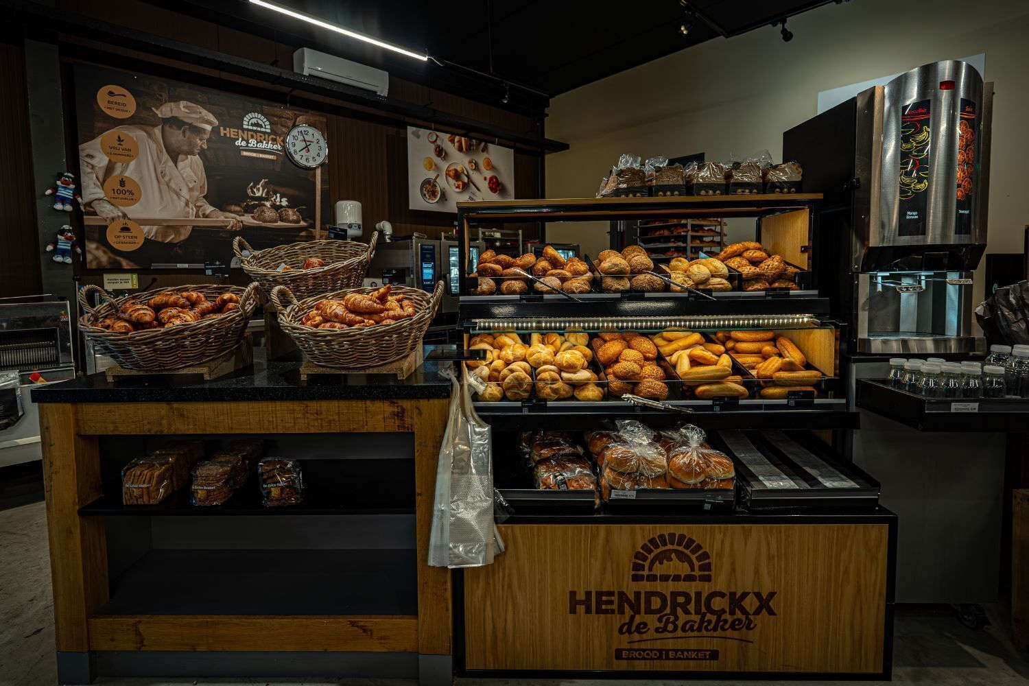 A bakery display with various baked goods, including bread and pastries, in a store.