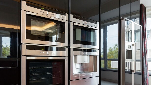 A modern kitchen with built-in ovens and a large window. - Hyde Park Heights, by Veeve (London)