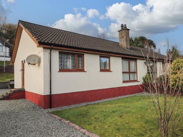 A single-story house with a sloped roof, a chimney, and a satellite dish. - The Hideout (Portree)