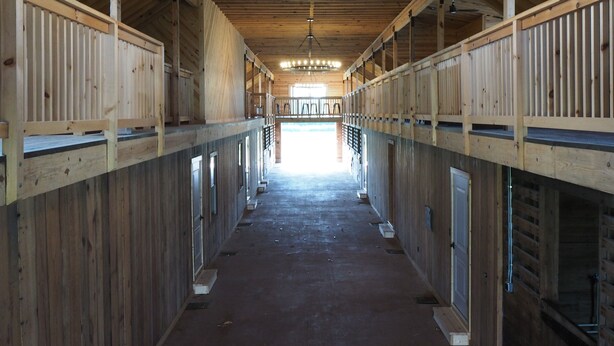 A long, narrow corridor with wooden walls and a high ceiling. - Golf & Hunting Retreat - Luxury Historic Barn Near Pinehurst (Southern Pines)