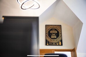 A room with a black and gold framed motivational poster on the wall.