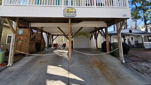 A two-story building with a balcony, a sign reading "Margaritaville," and a covered area with tables and chairs.
