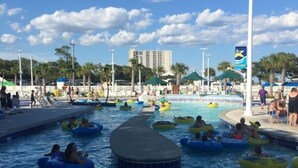A pool area with multiple lanes for water activities, including a central lane and several smaller lanes with inflatable tubes.